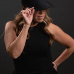 Thumbnail of http://Woman%20looking%20to%20the%20side%20while%20wearing%20a%20black%20hat%20with%20the%20ONX%20logo
