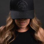 Thumbnail of http://Woman%20wearing%20black%20hat%20with%20ONX%20logo