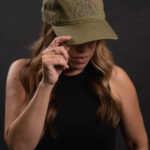 Thumbnail of http://Woman%20wearing%20green%20hat%20with%20ONX%20logo