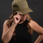 Thumbnail of http://Woman%20wearing%20green%20hat%20with%20ONX%20logo