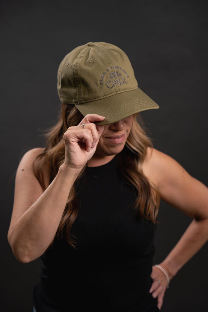 Image of http://Woman%20wearing%20green%20hat%20with%20ONX%20logo